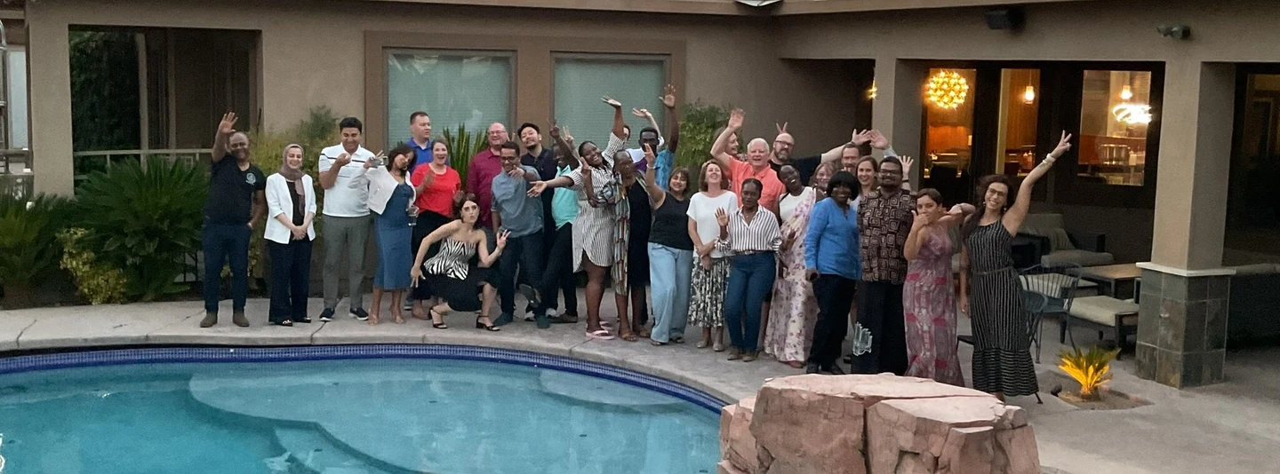 A group gathered beside a pool in the photograph accompanying WACLV’s 2025 dinner-diplomacy account
